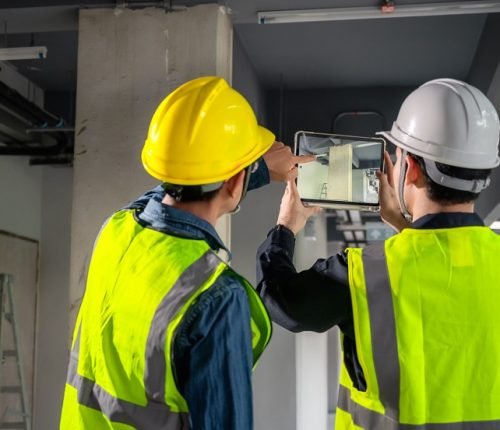 Engineer, architect and construction supervisor Use tablet to record information while inspecting construction work. Construction supervisor, architect or engineer inspect construction inside building